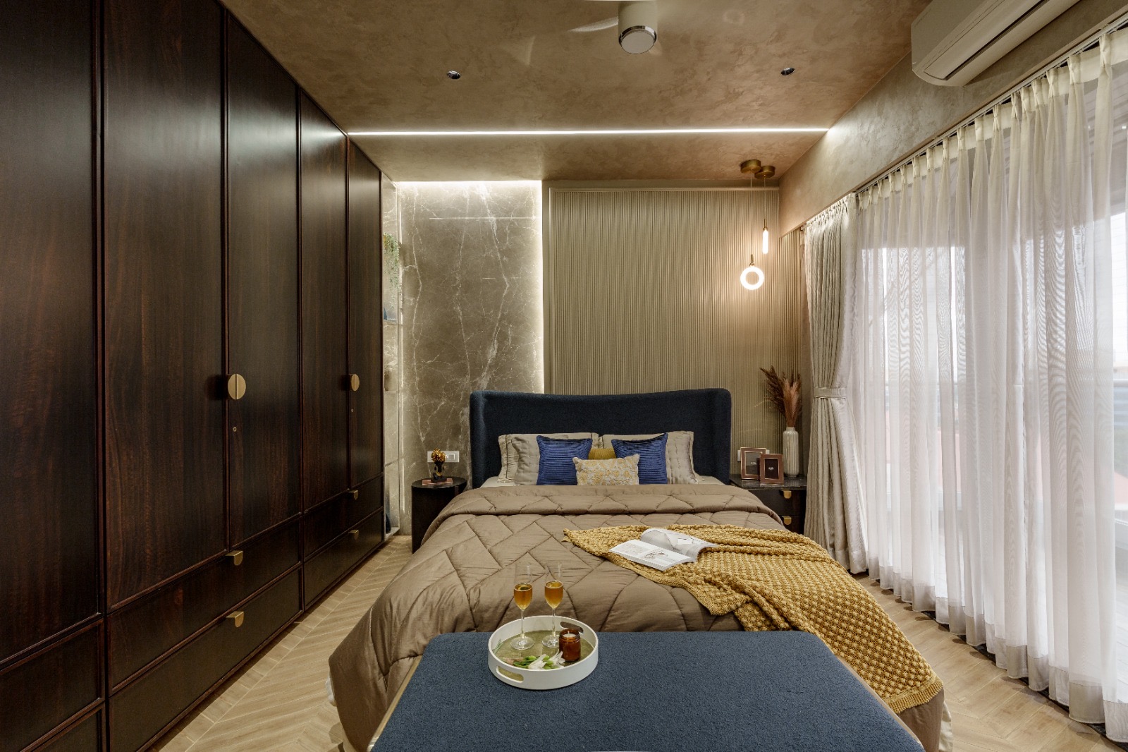 Quilted comforter, throw and cushions on a bed in a SPACIYOUS-furnished bedroom